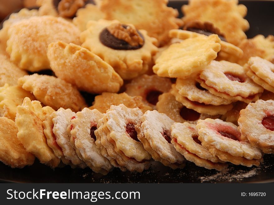 Delicious cookies on a black plate