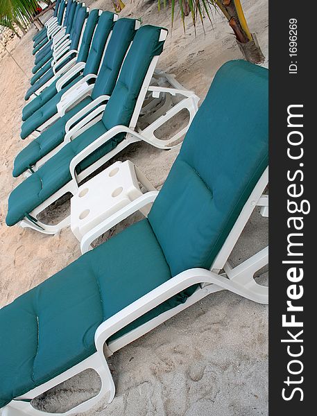 Row of green beach chairs at the beach