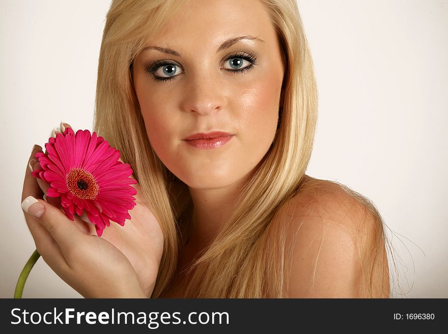 Beautifull woman with red flower in her hands