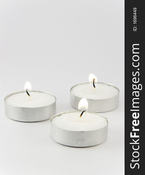 Three candles ignited with a space on them to write