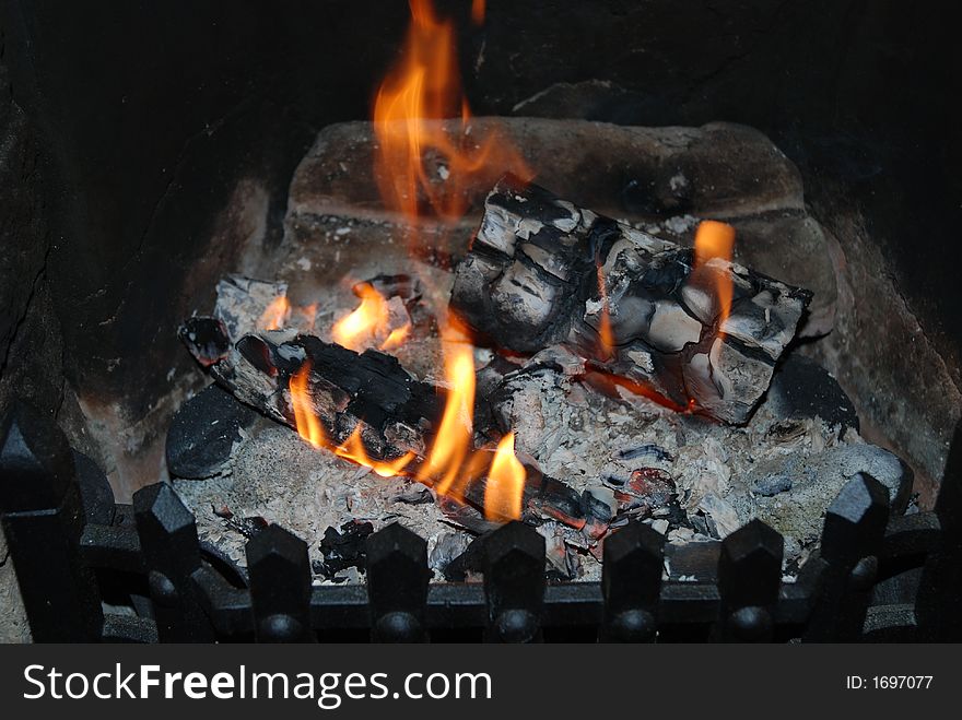 An open log fire warming up a winter evening. An open log fire warming up a winter evening