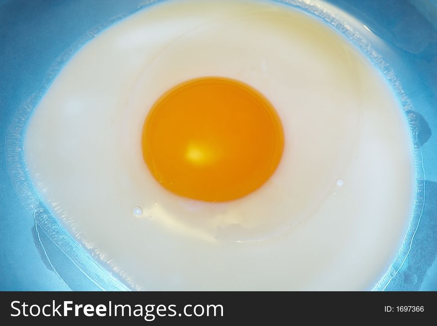 One egg on a blue plate