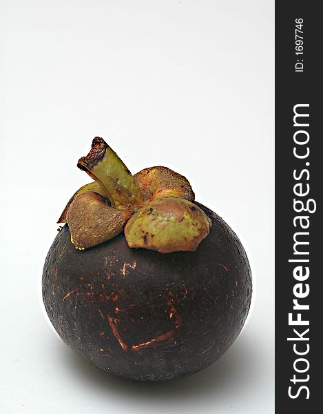One isolated mangosteen on a white background.