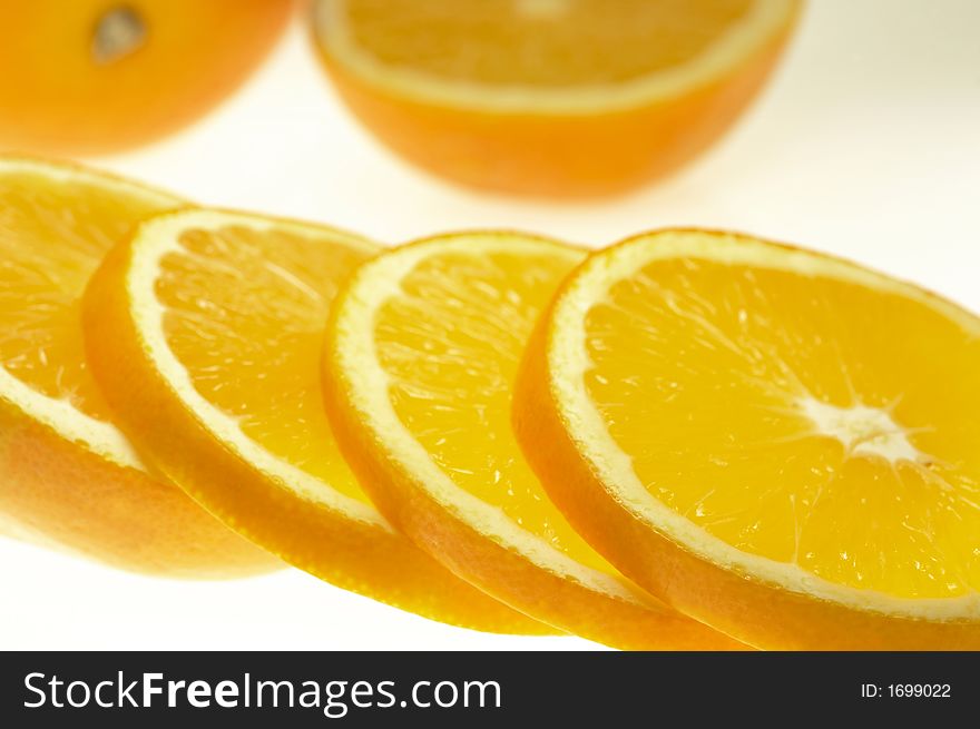 Pieces of nice juicy sliced orange on white sheet. Pieces of nice juicy sliced orange on white sheet