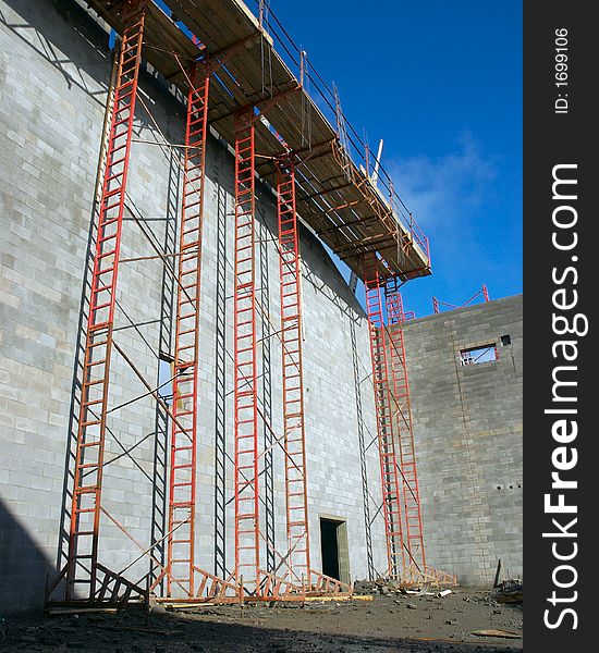 A construction site with ladders and a blue sky background. A construction site with ladders and a blue sky background