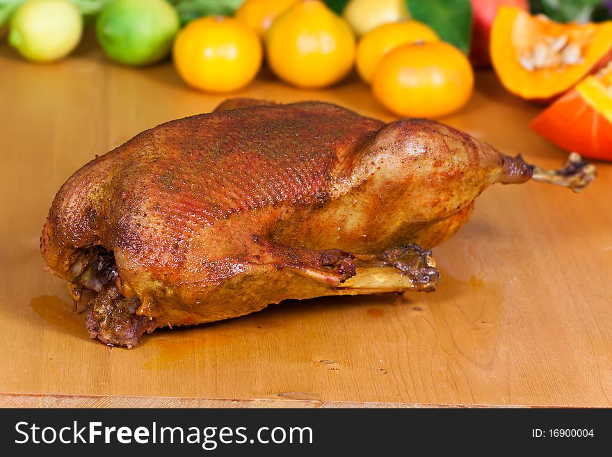 Fresh Baked Goose with decoration of fruits .