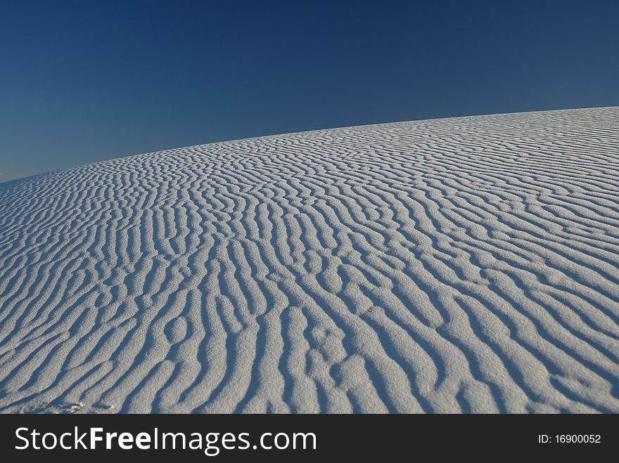 A giant gypsum sand dune from White Sands National Monument in New Mexico. A giant gypsum sand dune from White Sands National Monument in New Mexico.