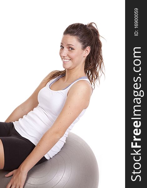 A woman is leaning back on a fitness ball. A woman is leaning back on a fitness ball