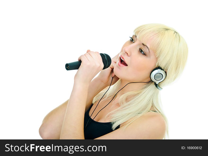 Pretty girl sings to microphone in headphones. Pretty girl sings to microphone in headphones