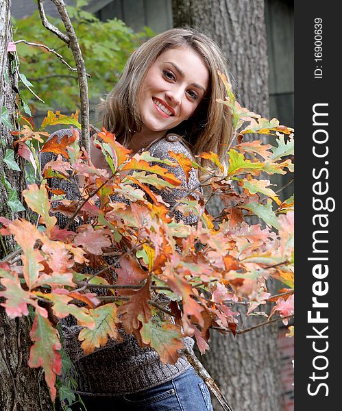 Happy young woman in autumn setting