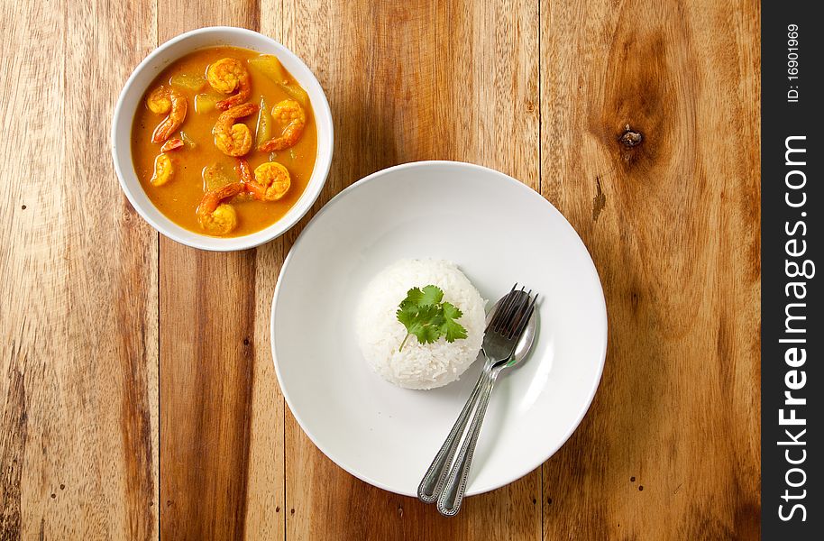 Shrimp curry with rice on wood background,thai food. Shrimp curry with rice on wood background,thai food.