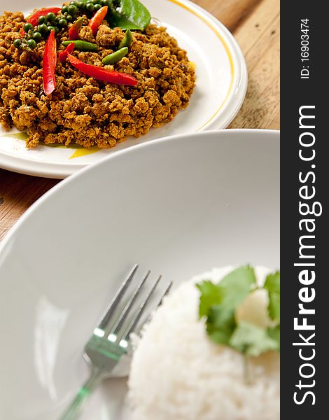 Spicy pork basil with rice on wood background,thai food. Spicy pork basil with rice on wood background,thai food.