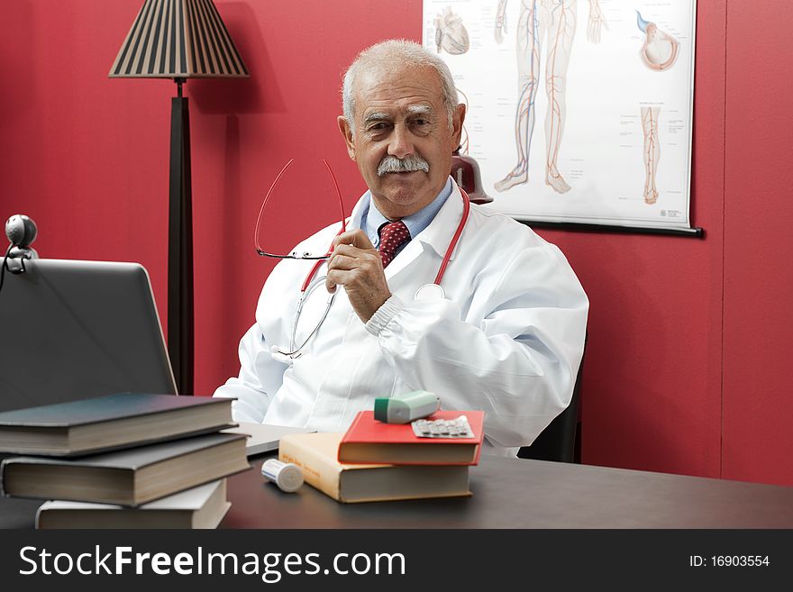 Portrait of a confident senior doctor smiling at camera. Portrait of a confident senior doctor smiling at camera