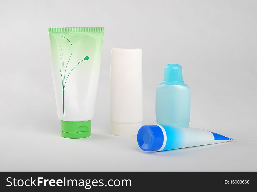 Different cosmetic bottles and tubes isolated on white background . Each object on different layer.