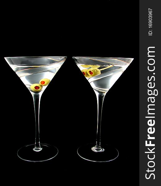 Two Martini's with olives isolated on Black Background
