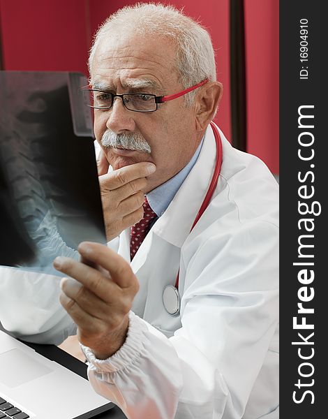 Senior doctor examining x-ray