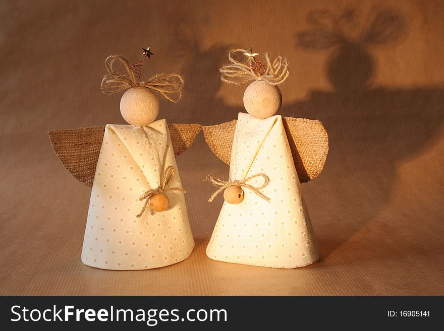 Two christmas angels with their shadows