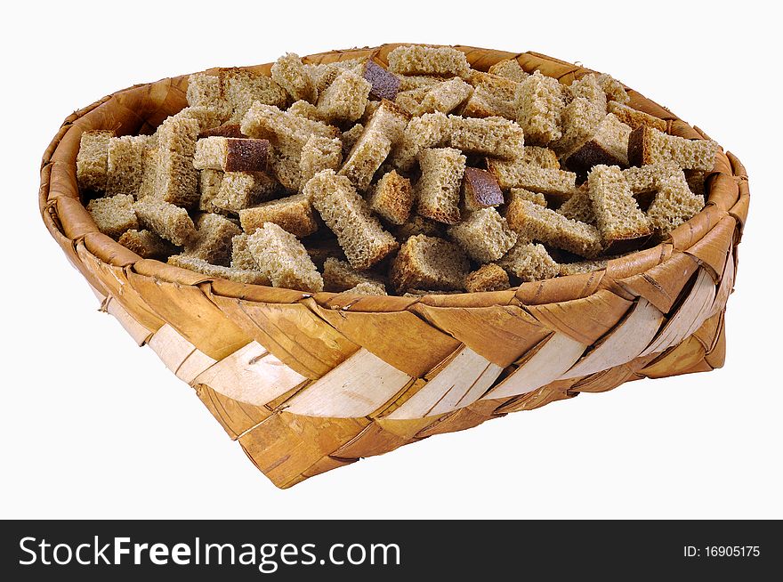 Home-made brown rusks in big birch-bark box over white background