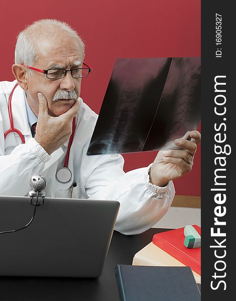 Senior doctor examining x-ray