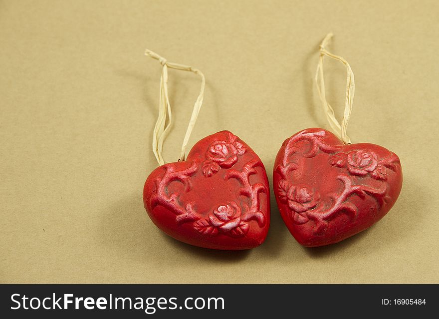 Two red hearts made of clay