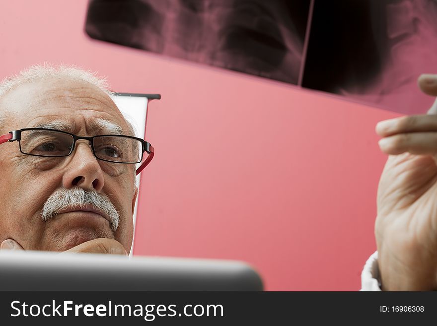 Senior doctor examining x-ray