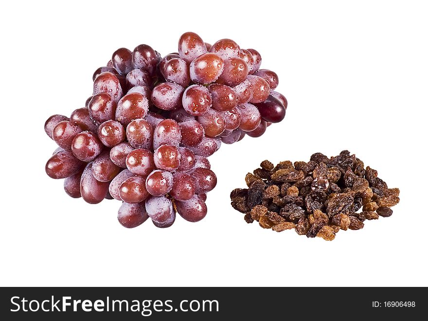 Bunch of red grapes and raisins on white background. Bunch of red grapes and raisins on white background
