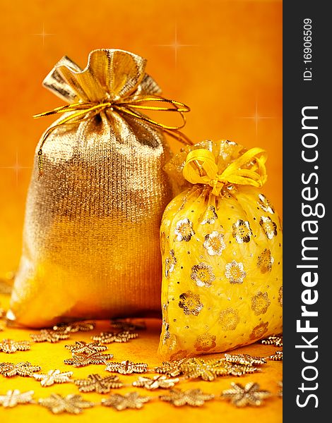 Golden christmas gift sacks and golden snowflake