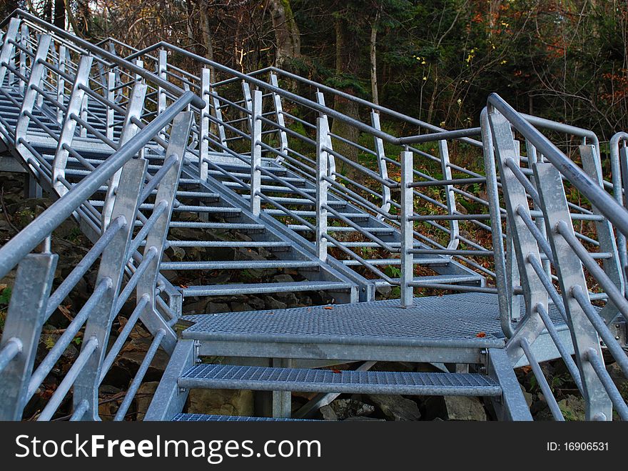 Metal stairs with landing in the mountains.