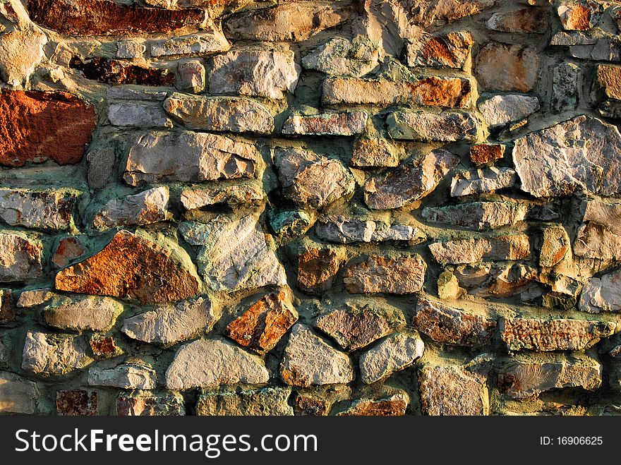 Traditional stone brick wall made of fragment stones in irregular shapes. Traditional stone brick wall made of fragment stones in irregular shapes.