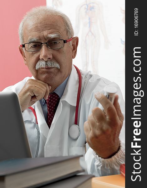 Senior doctor speaking with patient through webcam. Senior doctor speaking with patient through webcam