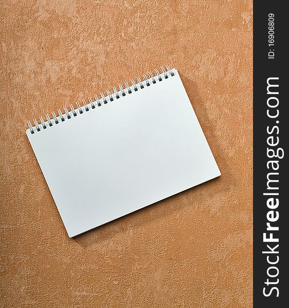 Spiral notebook on painted background