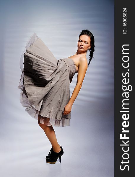 Fashion brown-haired model on grey background. Fashion brown-haired model on grey background
