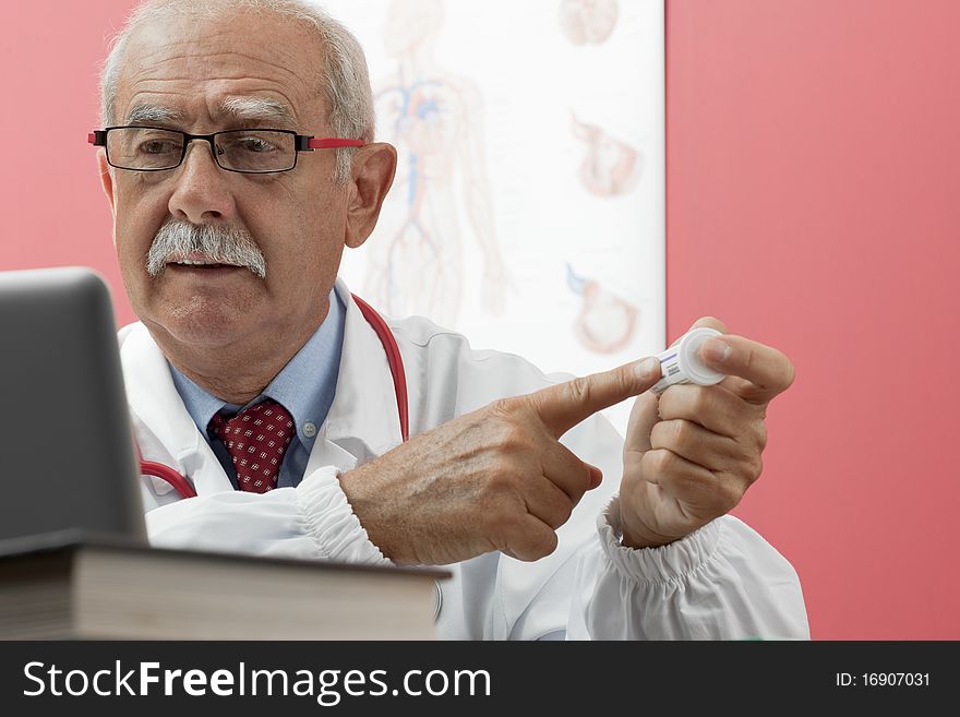 Senior doctor speaking with patient through webcam. Senior doctor speaking with patient through webcam