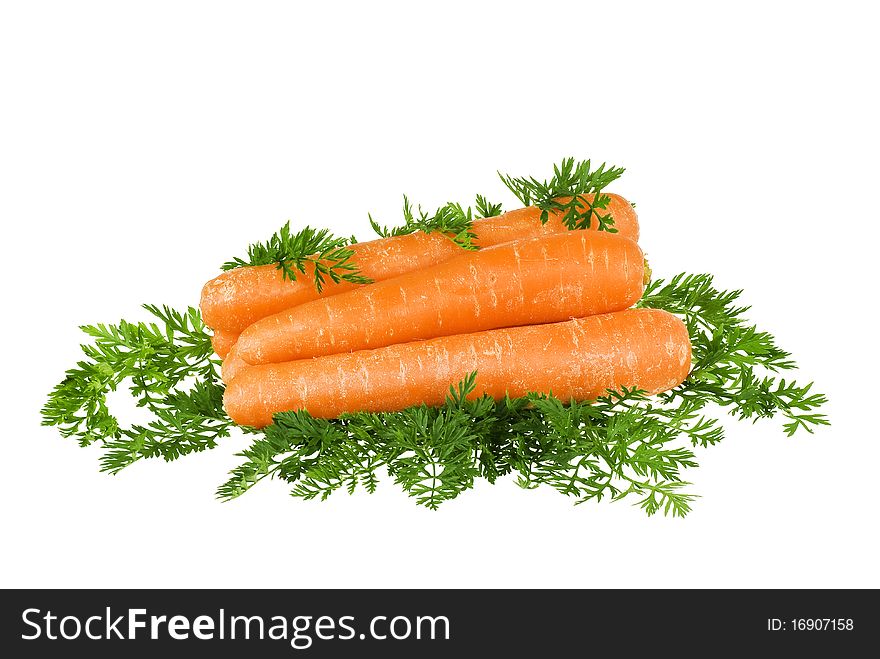 Carrots stacket up with leaves around on white background