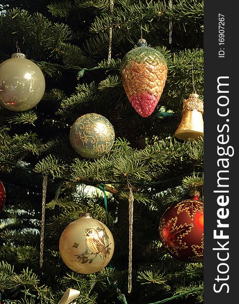 Various colorful christmas decorations on fir tree
