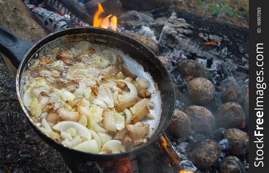 Tasty fried lard with onion and baked barbecue potatoes. Tasty fried lard with onion and baked barbecue potatoes