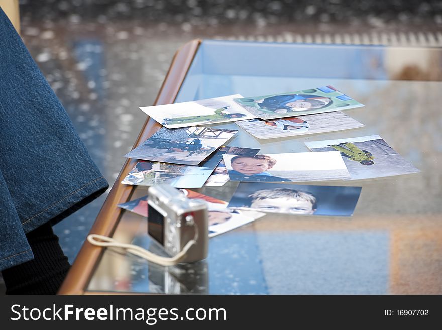 Photographs spread over the table. Photographs spread over the table