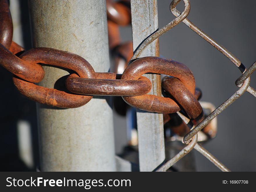 Steel chain closes the passage through the mesh gate.