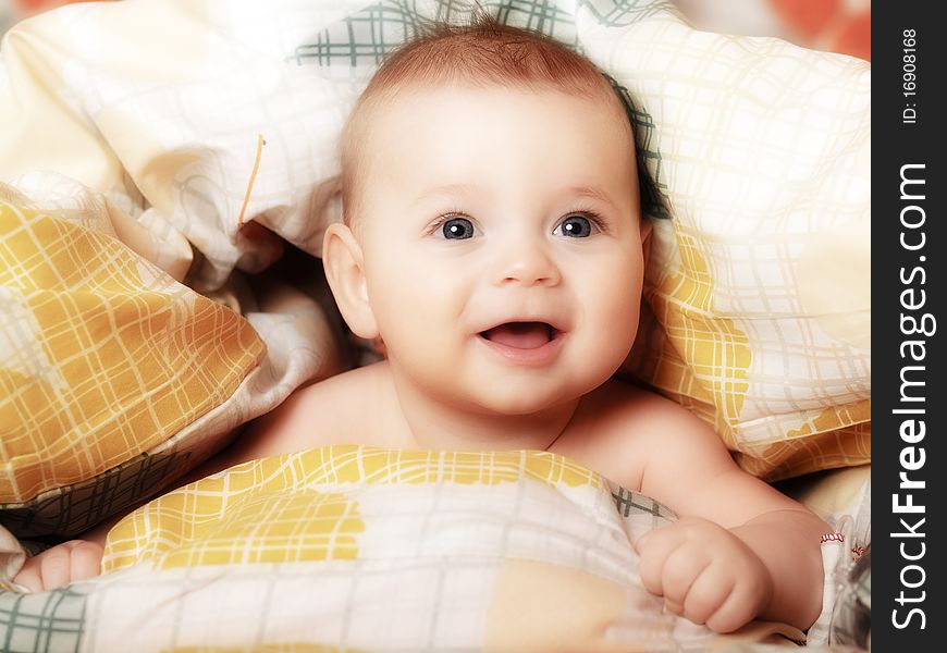 Newborn baby lying in bed