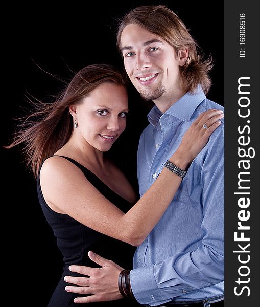 Young cute couple with long hair over black background. Young cute couple with long hair over black background.