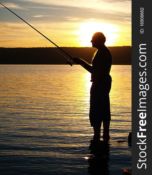 Man fishing on the coast of sea in sunset. Man fishing on the coast of sea in sunset