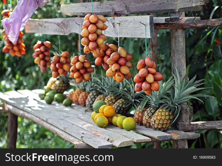 Fruit for sale by a road in the middle of a rainforest in Madagascar. Focus on right hand side of image. Fruit for sale by a road in the middle of a rainforest in Madagascar. Focus on right hand side of image