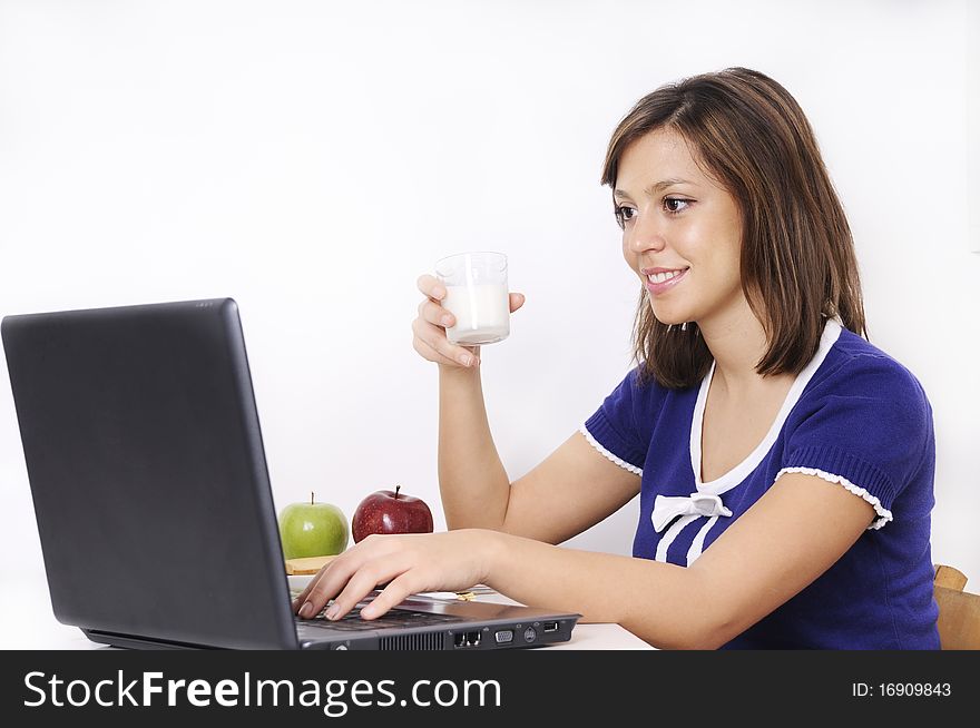 Young woman in breakfast, drinking and using laptop. Young woman in breakfast, drinking and using laptop