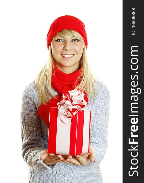 Young beautiful woman in a blue knitted sweater, red hat and red scarf holding a Christmas gift box. Young beautiful woman in a blue knitted sweater, red hat and red scarf holding a Christmas gift box