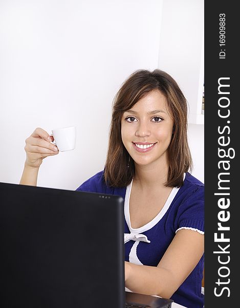 Young woman in breakfast, drinking coffee and using laptop. Young woman in breakfast, drinking coffee and using laptop