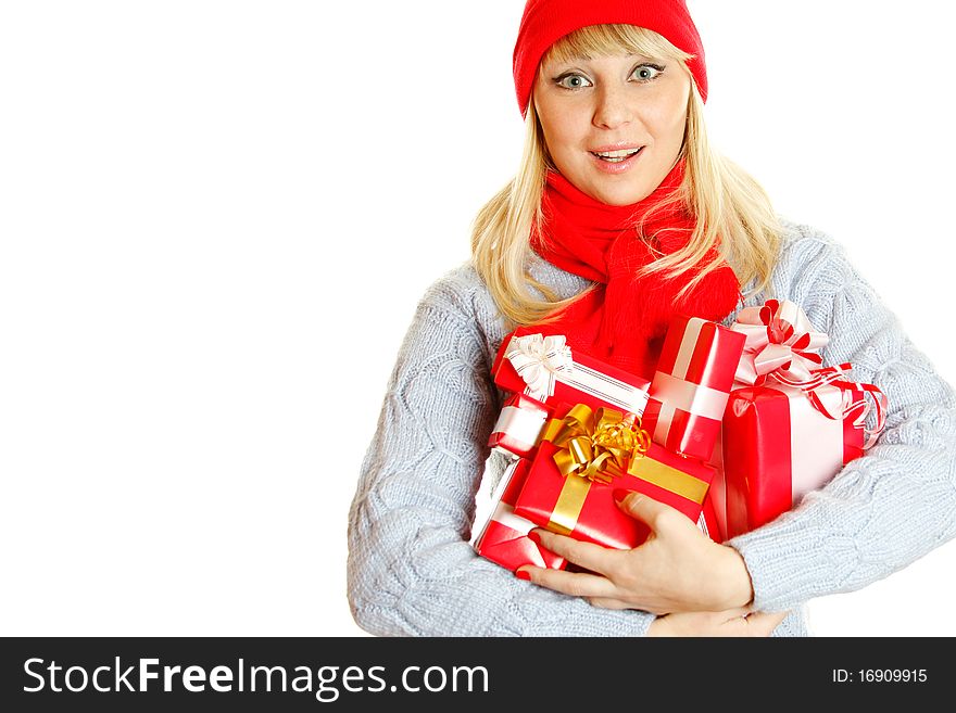 Young beautiful woman in a blue knitted sweater, red hat and red scarf hold many different sizes Christmas gift boxes. Expresses the delight and joy. Young beautiful woman in a blue knitted sweater, red hat and red scarf hold many different sizes Christmas gift boxes. Expresses the delight and joy