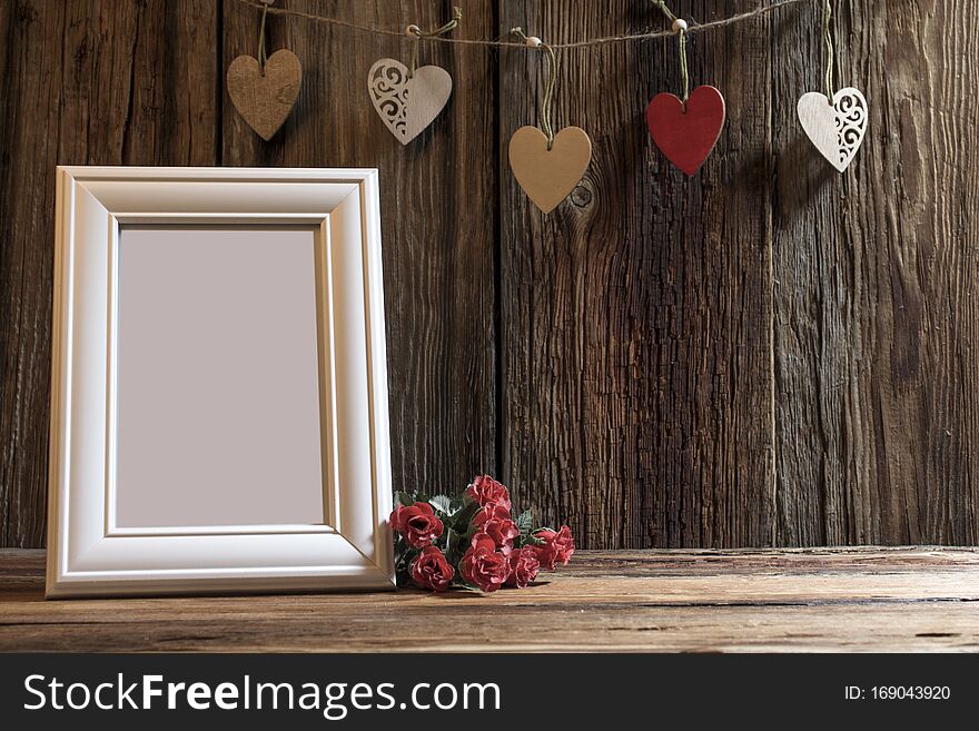 Holiday card for Valentine`s day a glass with red hearts on the background of a vintage lantern and pine branches with the text