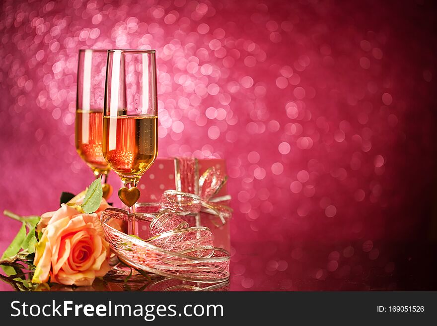 Champagne glasses on a beautiful bokeh background. Valentine`s day. Background with copy space. Selective focus.