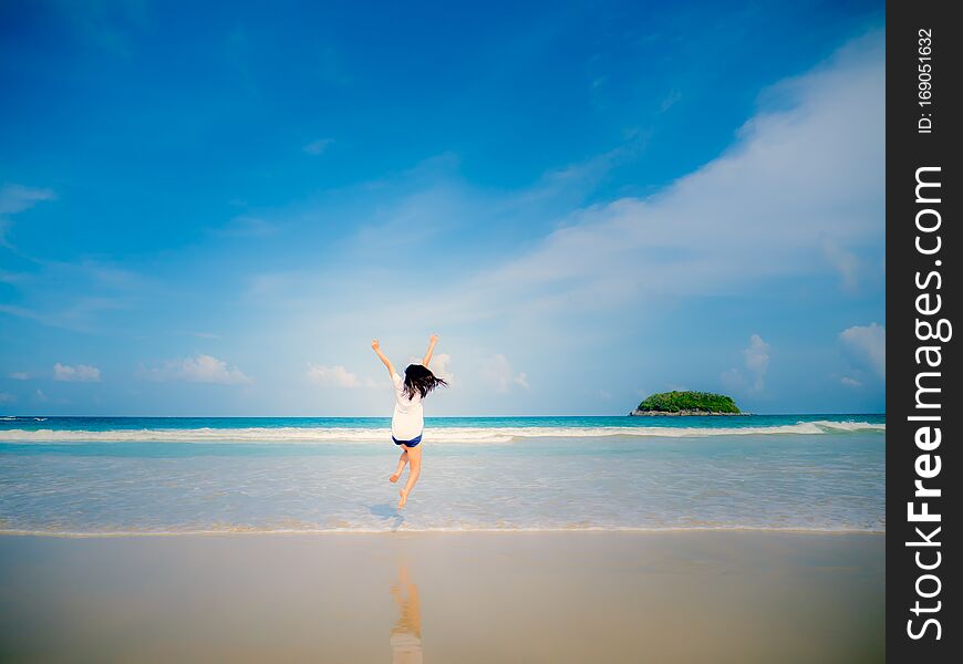 Woman jumping on the beach