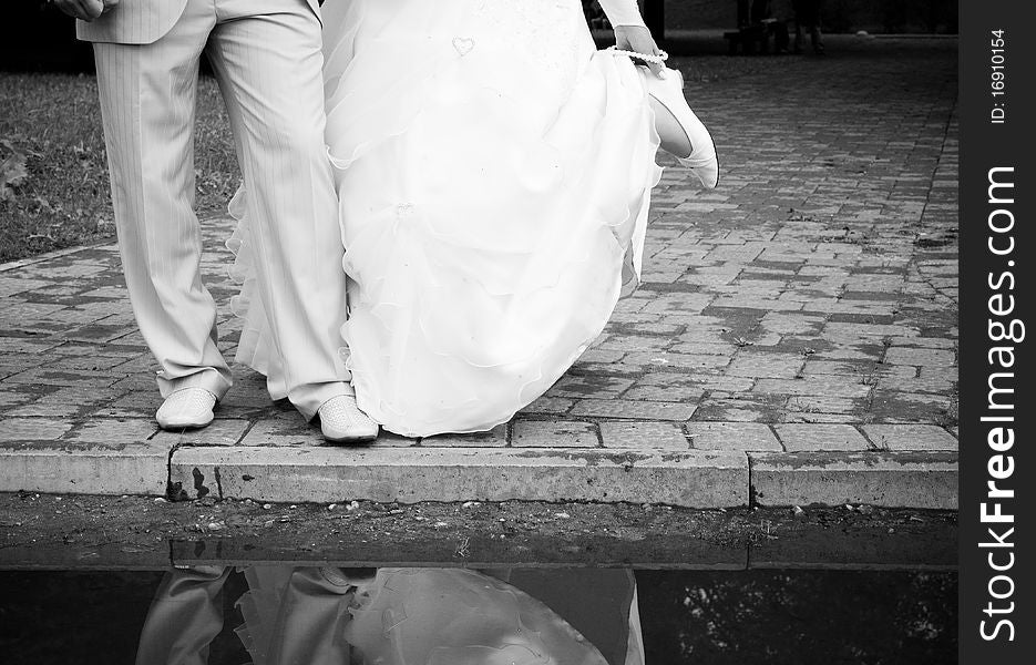 The groom' and bride's reflection in water. The groom' and bride's reflection in water